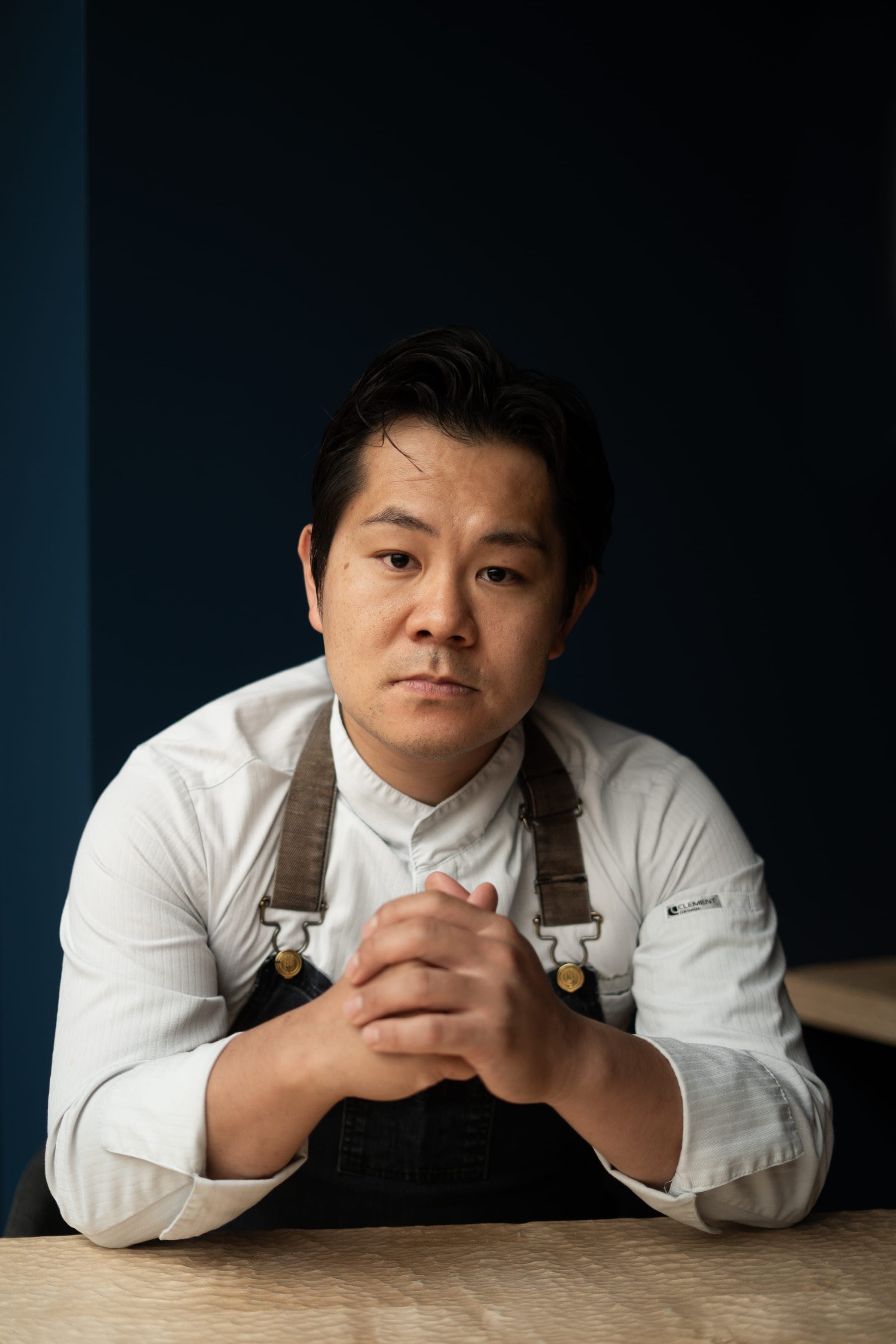 Portrait of chef Ryuichi Utsumi, hands clasped